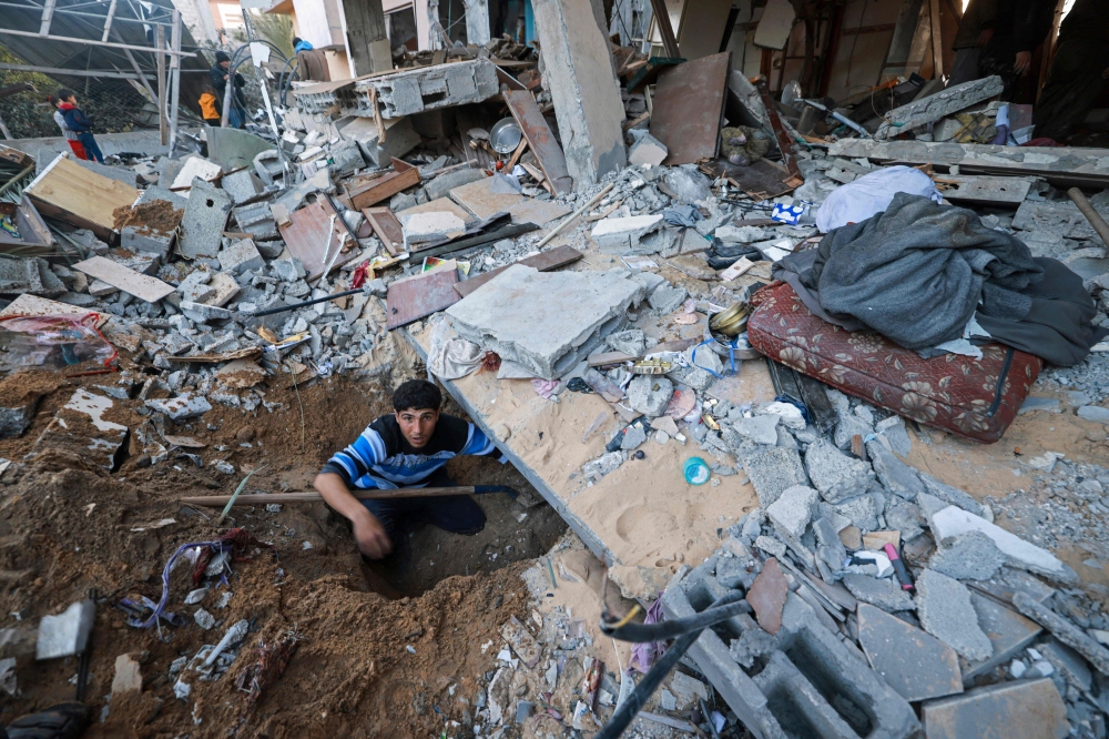 A man looks for survivors amid the debris of destroyed houses in the aftermath of Israeli bombardment in Rafah in the southern Gaza Strip on February 22, 2024, amid continuing battles between Israel and the Palestinian group Hamas. — AFP pic