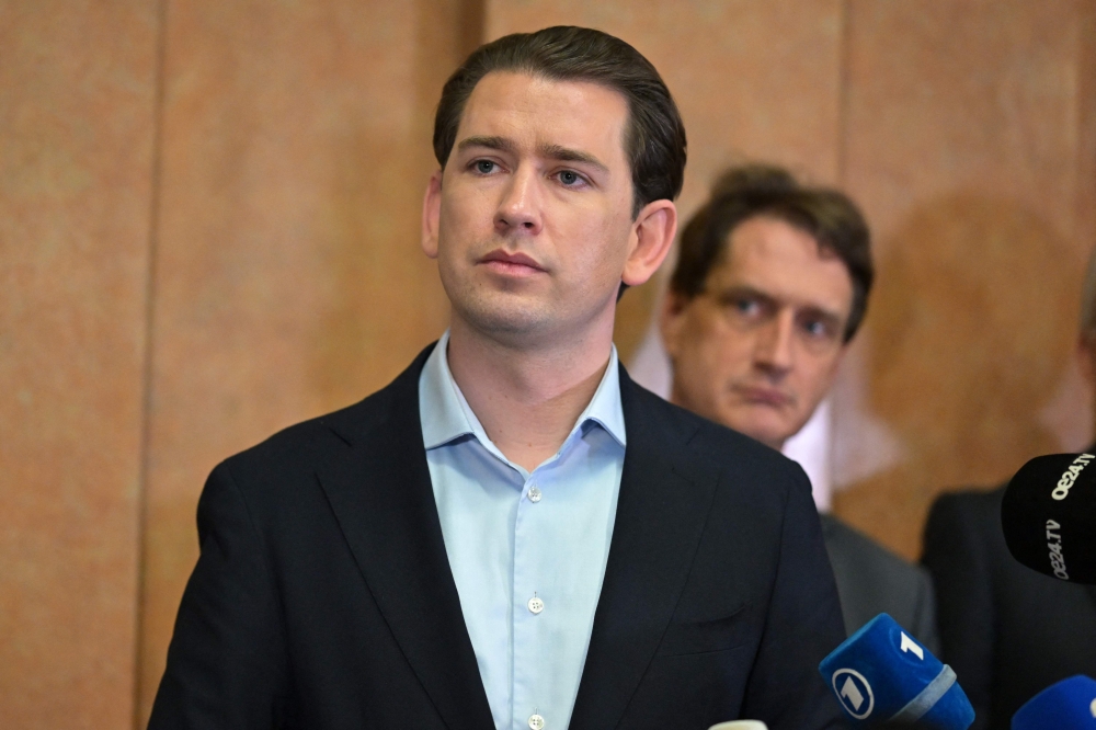 Austria's former Chancellor Sebastian Kurz speaks to journalists as he leaves the court after his trial at the Regional Criminal Court of Vienna, Austria, on February 23, 2024, where his verdict has announced following a months-long trial for alleged false testimony. — AFP pic