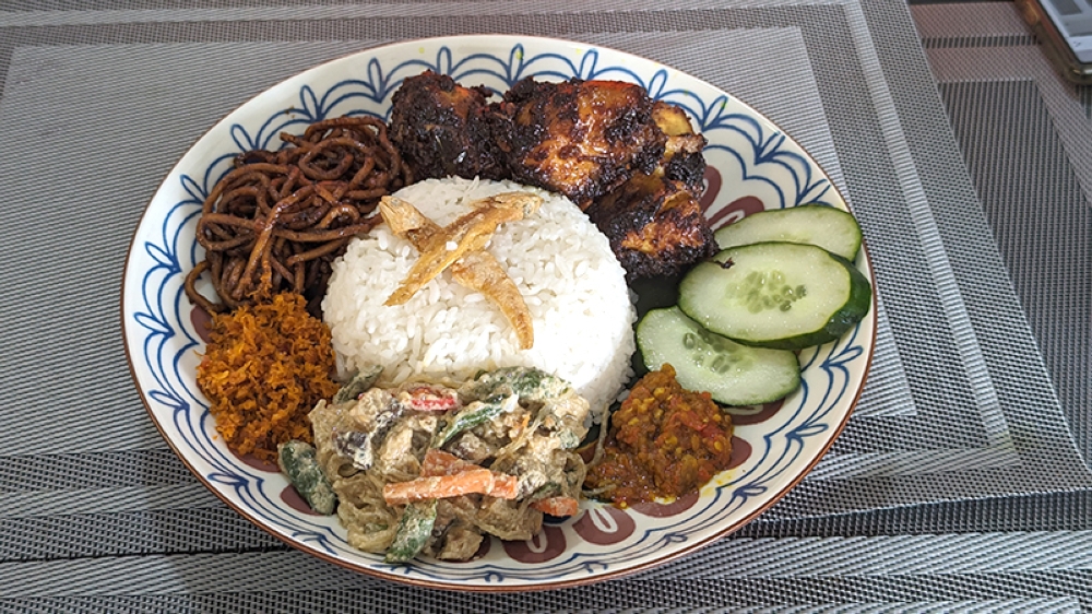 Nasi Ambeng is a Javanese dish of steamed white rice, chicken curry, beef or chicken rendang, bergedel, and serunding. Popular in Johor and Selangor. — Picture by Ethan Lau
