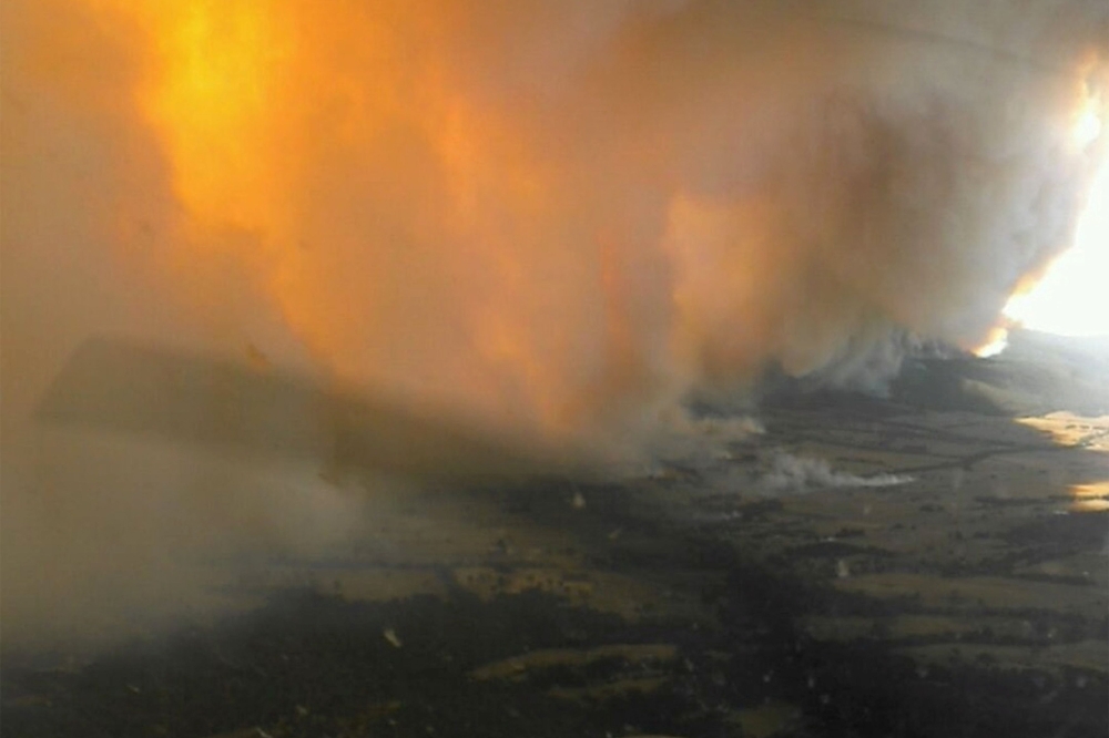More than 1000 firefighters are working to contain a large bushfire raging in Western Victoria as hot conditions set in across NSW. — Reuters pic