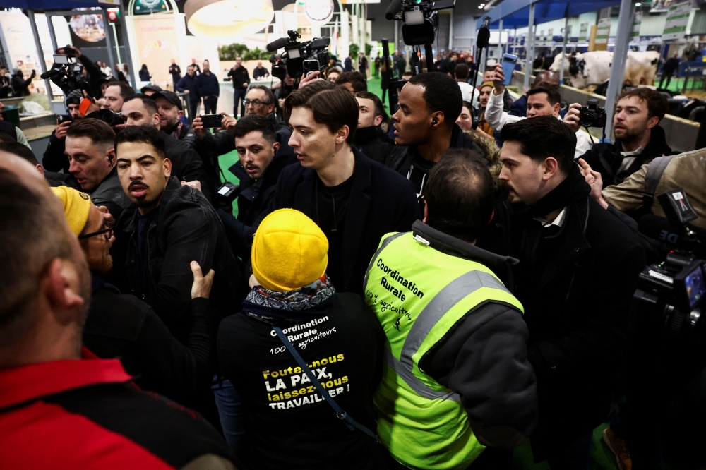 Farmers protest inside the Porte de Versailles exhibition centre on the day of French President Emmanuel Macron’s visit to the International Agriculture Fair (Salon International de L’agriculture) during its inauguration in Paris, France, February 24, 2024. — Reuters pic