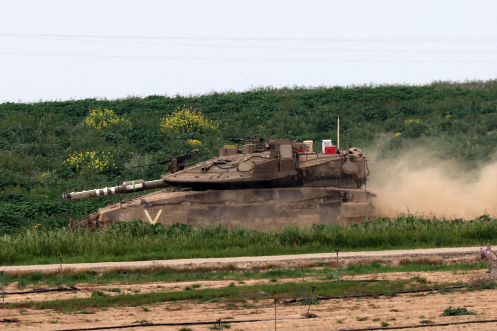 An Israeli tank rolls along the border with the Gaza Strip on February 23, 2024, amid ongoing battles between Israel and the Palestinian militant group Hamas. — AFP pic