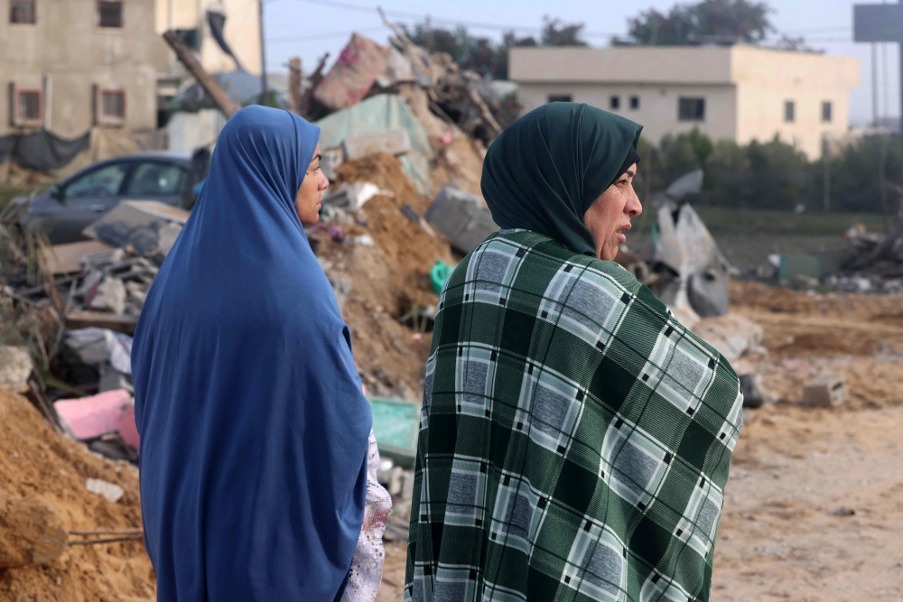 Women stand amid the destruction following overnight Israeli bombardment in Rafah in the southern Gaza Strip on February 23, 2024, as battles between Israel and the Palestinian militant group Hamas continue. — AFP pic