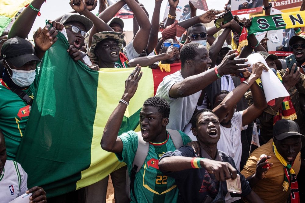 Opposition supporters chant during a demonstration in Dakar on February 24, 2024. Dakar residents are called to demonstrate on Saturday, either to put pressure on the head of state and get him to organize the presidential election before the official expiration of his mandate on April 2, or to support him. — AFP pic
