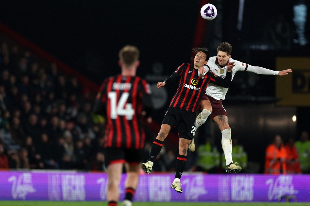 Manchester City's English defender #05 John Stones vies with Bournemouth's Turkish striker #26 Enes Unal during the English Premier League football match between Bournemouth and Manchester City at the Vitality Stadium in Bournemouth, southern England on February 24, 2024. — AFP pic