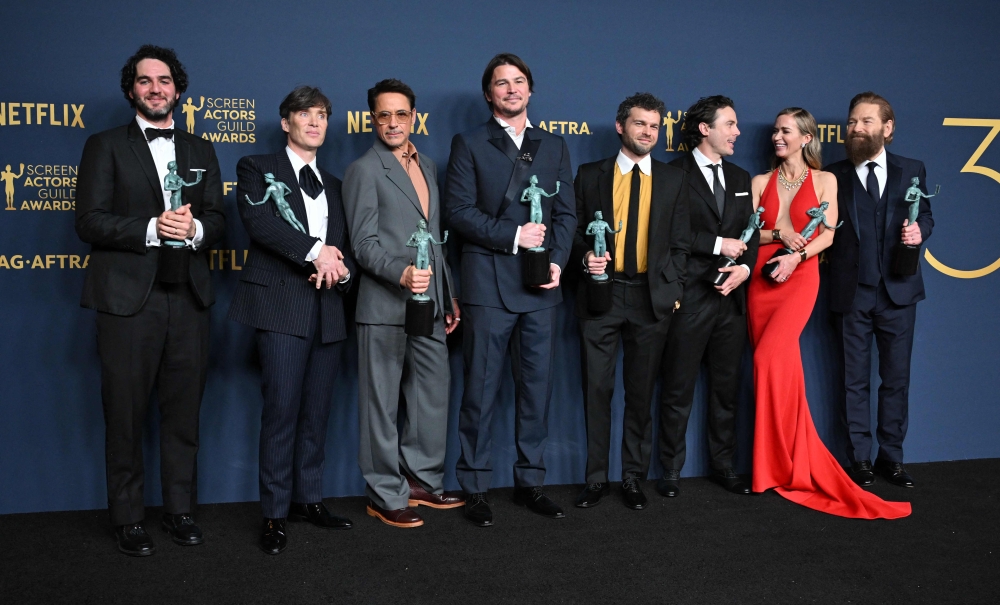 (L-R) Benny Safdie, Cillian Murphy, Robert Downey Jr., Josh Hartnett, Alden Ehrenreich, Casey Affleck, Emily Blunt and Kenneth Branagh, winner of the Outstanding Performance by a Cast in a Motion Picture award for ‘Oppenheimer’ pose in the press room during the 30th Annual Screen Actors Guild Awards at the Shrine Auditorium in Los Angeles, February 24, 2024. — AFP pic