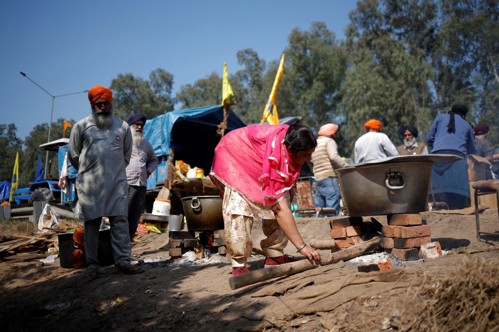 Rajbir Kaur, 38, prepares food for the farmers, at a protest site during the march towards New Delhi to push for better crop prices promised to them in 2021, at Shambhu Barrier, the border between Punjab and Haryana states, India February 23, 2024. — Reuters pic