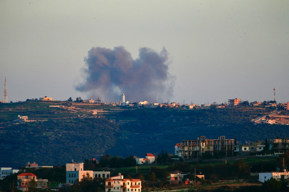 Smoke billows following an Israeli air raid that targeted an area between the Lebanese border villages of Ramia and Marwahin on February 21, 2024. — AFP pic