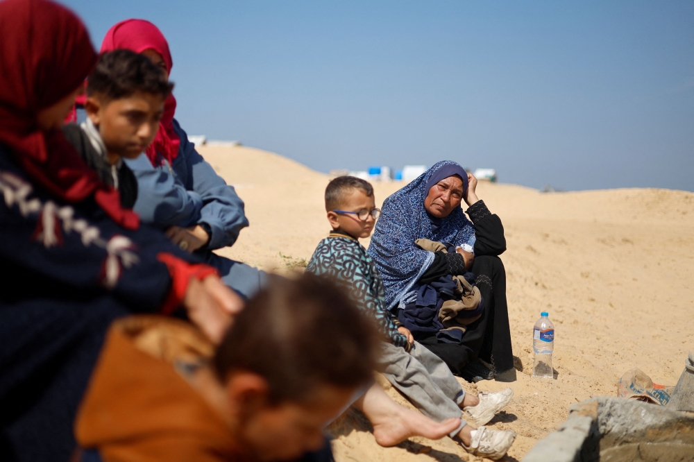 Palestinians visit a cemetery, amid the ongoing conflict between Israel and the Palestinian Islamist group Hamas, in Rafah in the southern Gaza Strip, February 26, 2024. — Reuters pic