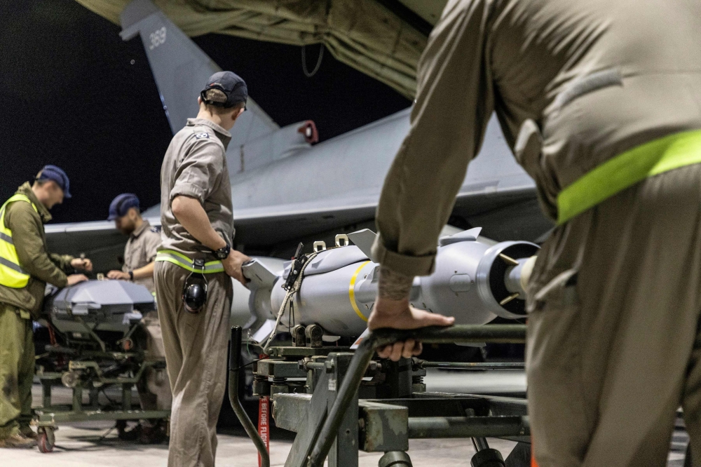 A handout picture released by the British Ministry of Defence (MOD) on February 24, 2024 shows a Royal Air Force Typhoon FGR4 having Paveway IV weapons loaded by Weapon Technicians at RAF Akrotiri in Cyprus, in preparation for a strike on military targets in Yemen February 22, 2024. — AFP pic