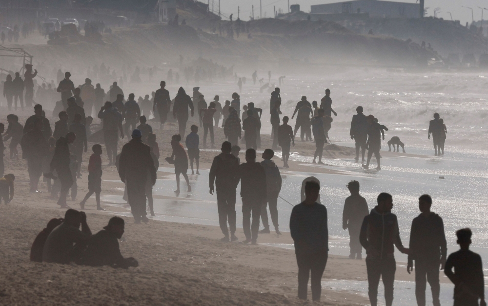 Palestinians gather on a beach in the hope of getting aid air-dropped over Gaza, amid the ongoing the conflict between Israel and Hamas, in the southern Gaza Strip February 27, 2024. — Reuters pic