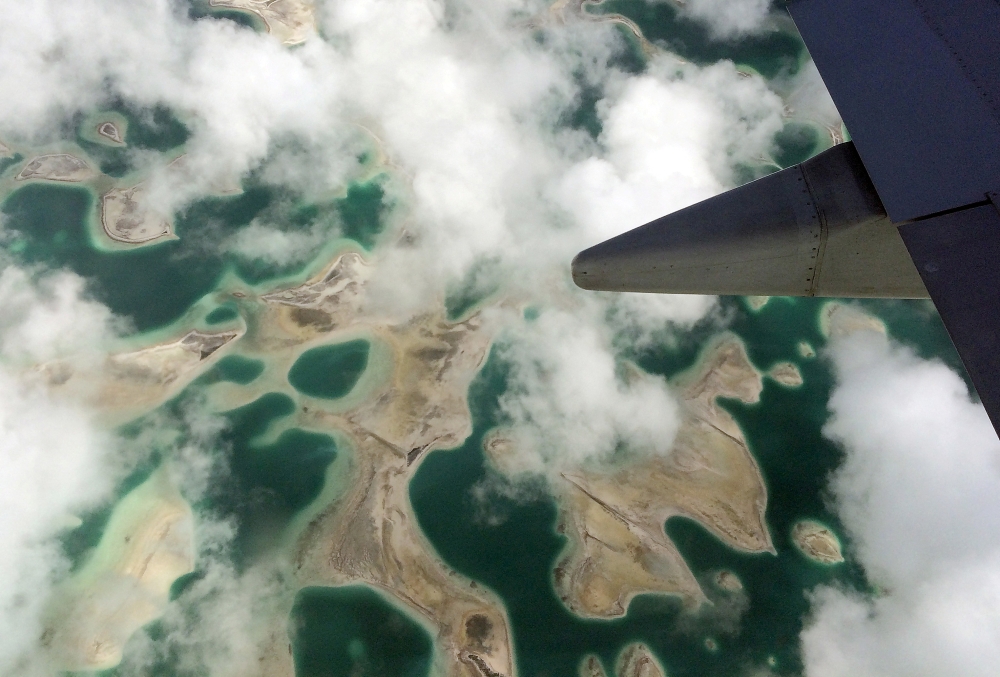 Lagoons can be seen from a plane as it flies above Kiritimati Island, part of the Pacific Island nation of Kiribati. — Reuters pic