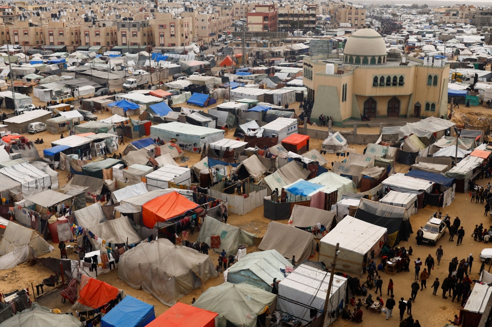 Displaced Palestinians, who fled their homes due to Israeli bombing, shelter at a tent camp in Rafah. — Reuters pic