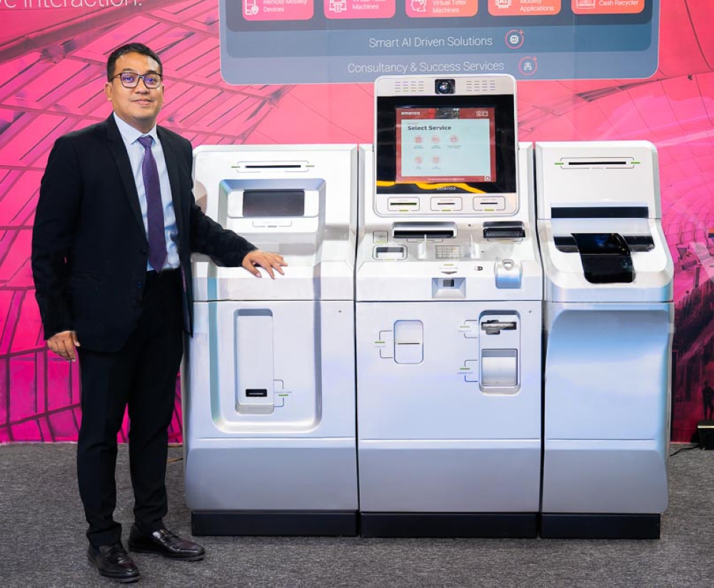 Emerico CEO Azlan Ashari poses with the X-series Virtual Teller Machine. — Picture courtesy of Emerico