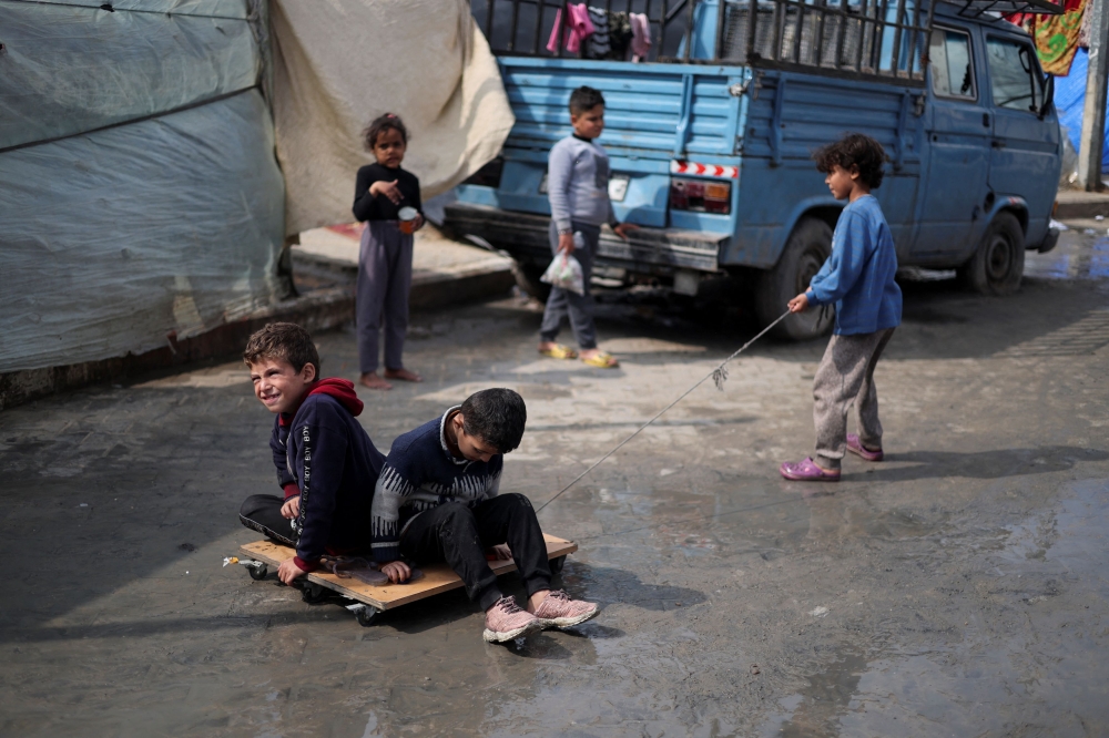 Displaced Palestinian children, who fled their houses due to Israeli strikes, shelter at a tent camp, amid the ongoing conflict between Israel and Hamas, in Rafah in the southern Gaza Strip, February 27, 2024. — Reuters pic