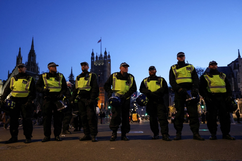 Police officers stand guard near the Palace of Westminster in Whitehall, as people protest in solidarity with Palestinians in Gaza, during a temporary truce between Palestinian Islamist group Hamas and Israel, in London, Britain, November 25, 2023. Mark Rowley, the head of the London’s Metropolitan Police (MPS), began a major purge of his force, and he has said hundreds of officers were likely to be sacked for sexual and domestic abuse offences. — Reuters pic