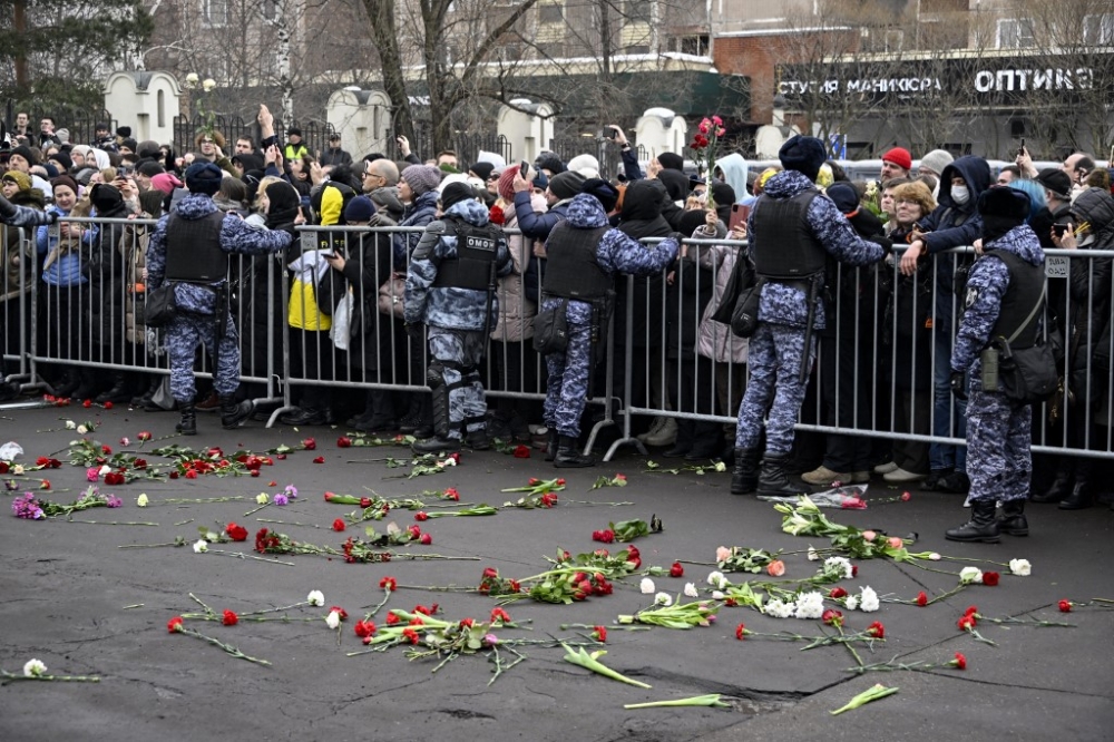Mourners react as the hearse carrying the coffin of late Russian opposition leader Alexei Navalny leaves the Mother of God Quench My Sorrows church towards the Borisovo cemetery for Navalny's burial, in Moscow's district of Maryino on March 1, 2024. — AFP pic