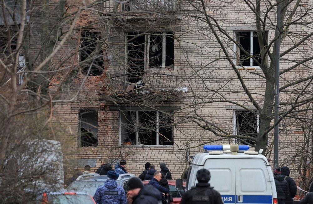 Members of emergency services and investigators gather near a damaged multi-storey residential building following an alleged drone attack in Saint Petersburg, Russia, March 2, 2024. — Reuters pic