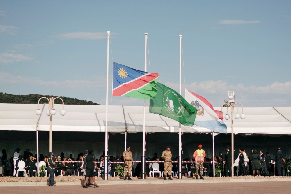 File photo of the flags of the Republic of Namibia (left), African Union (centre) and the Namibian Defence Forces  flying at half-mast for the late Namibian President Hage Geingob at Heroes Acre, south of Windhoek, Namibia, on February 25, 2024 during his funeral. — AFP pic