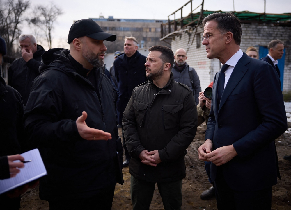 This handout photograph taken and released by Ukrainian Presidential Press Service on March 1, 2024, shows Ukrainian President Volodymyr Zelensky (centre) and Prime Minister of the Netherlands Mark Rutte (right) listening to explanations as they inspect damaged buildings in Kharkiv, amid the Russian invasion of Ukraine. — AFP pic