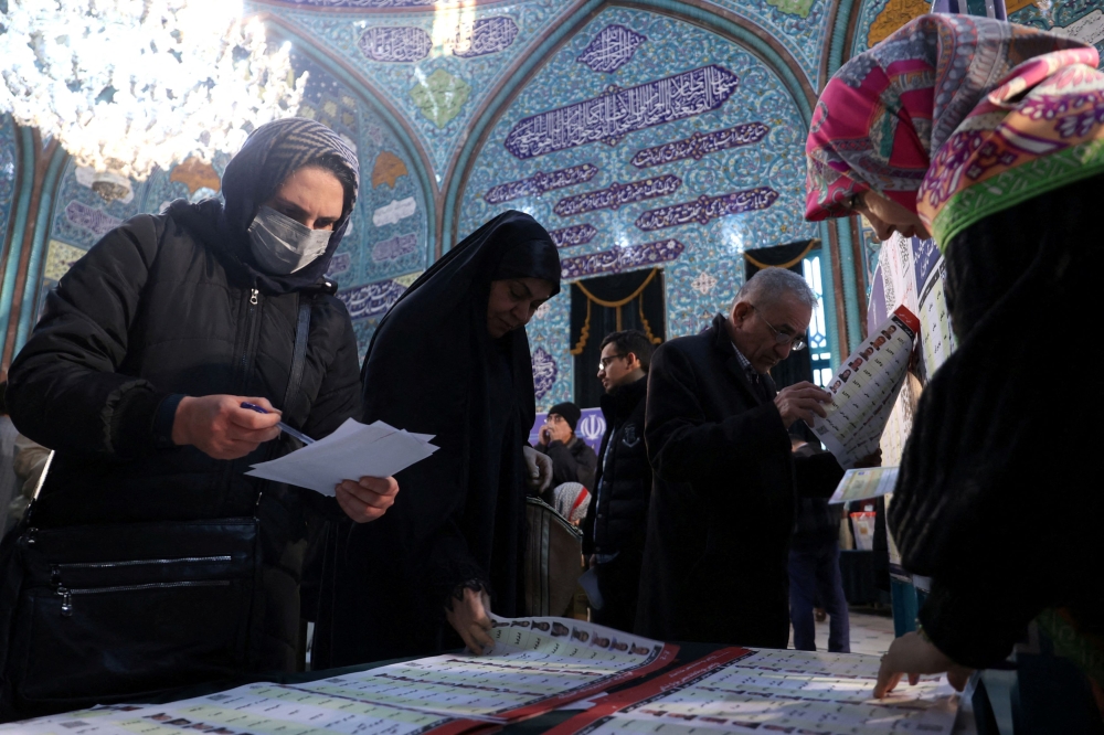 Iranians vote during the parliamentary election at a polling station in Tehran, Iran, March 1, 2024. — Reuters pic