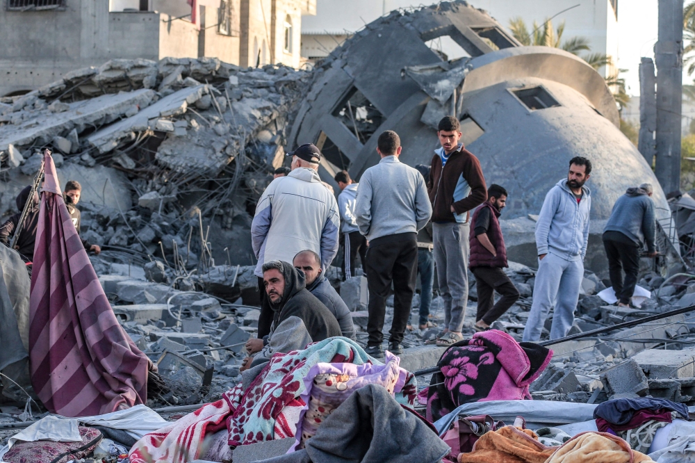 Palestinians stand amid the rubble of a Mosque that was destroyed in Israeli strikes in Deir El-Balah in central Gaza on March 2, 2024, as battles continue between Israel and the militant group Hamas. — AFP pic