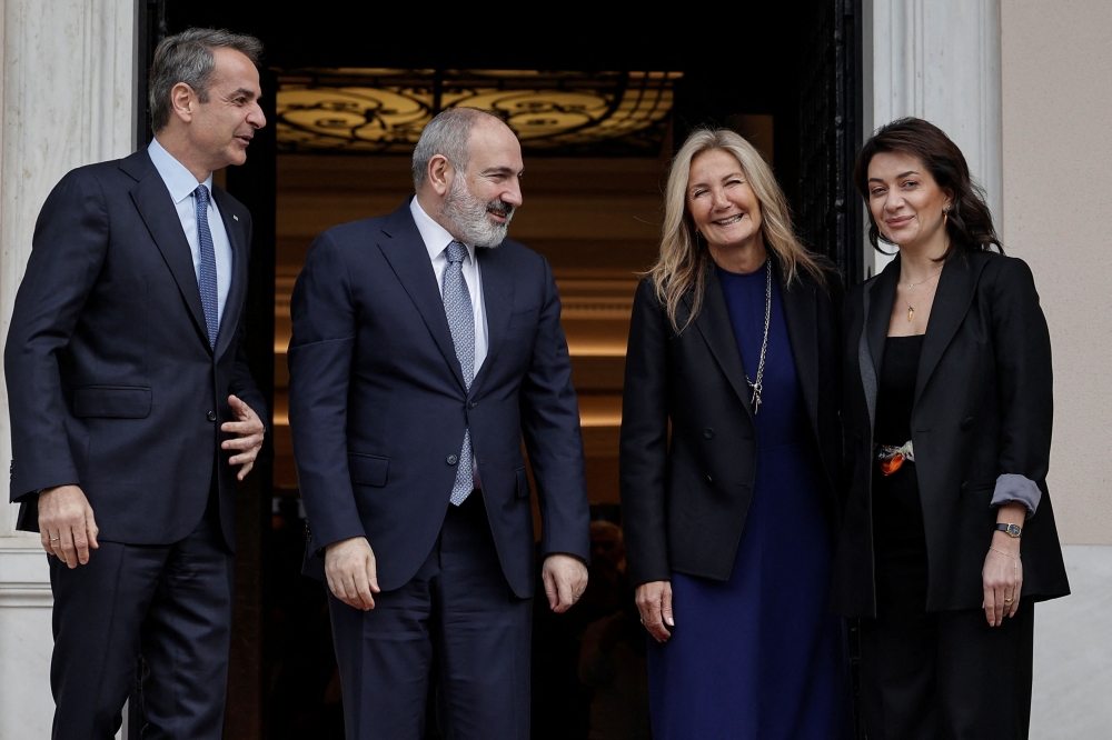 Greek Prime Minister Kyriakos Mitsotakis and his Armenian counterpart Nikol Pashinyan, stand along with their wives Mareva Grabowski-Mitsotakis and Anna Hakobyan upon their arrival for a meeting in Athens, Greece, February 27, 2024. — Reuters pic