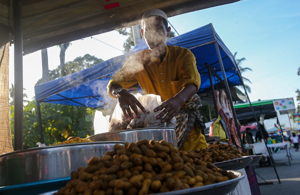 A trader at the Sungai Bayor market in Selama. — Picture by Farhan Najib
