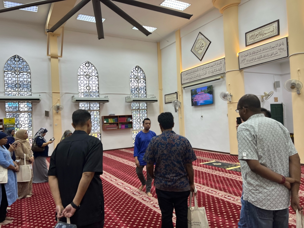 The Seberang Jaya Harmony Exploration programme allows participants to visit houses of worship and learn about the different religious practices. Here, participants are in Masjid Sembilang. — Picture by Opalyn Mok
