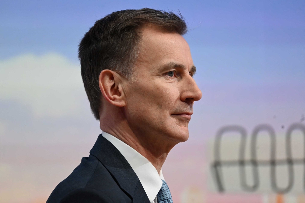 A handout picture released by the BBC, taken and received on March 3, 2024, shows Britain's Chancellor of the Exchequer Jeremy Hunt appearing on the BBC's 'Sunday Morning' political television show with journalist Laura Kuenssberg. — AFP pic