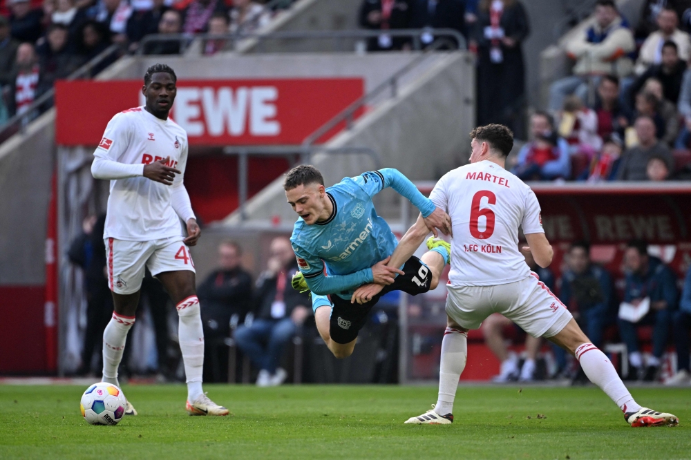 Bayer Leverkusen’s German midfielder Florian Wirtz (centre) vies for the ball with Cologne’s German midfielder #06 Eric Martel ® and Cologne’s German forward #40 Faride Alidou during the German first division Bundesliga football match FC Cologne v Bayer 04 Leverkusen in Cologne March 3, 2024. — AFP pic