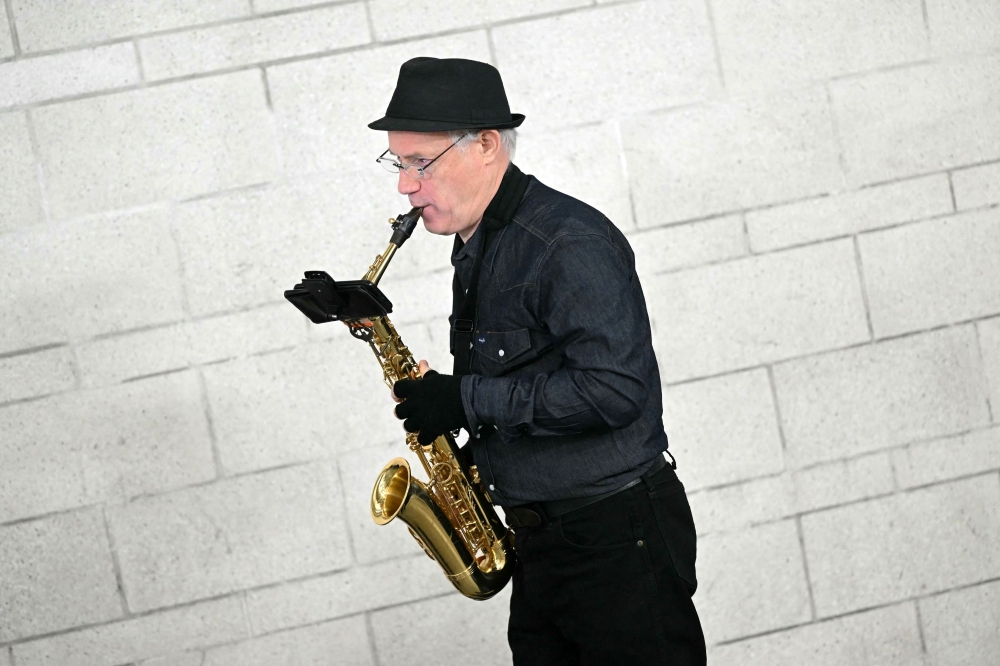 Andrew 'Sax' Bruell warms up before taking part in busking audition at Transport for London's (TFL) Southwark Underground tube station, in London, on February 28, 2024. — AFP pic