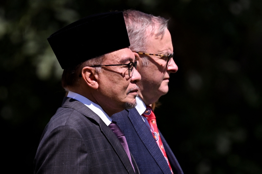 Malaysia's Prime Minister Datuk Seri Anwar Ibrahim and Australia's Prime Minister Anthony Albanese stand together during Anwar's ceremonial welcome during the Australia-Asean (Association of Southeast Asian Nations) summit in Melbourne on March 4, 2024. — AFP pic