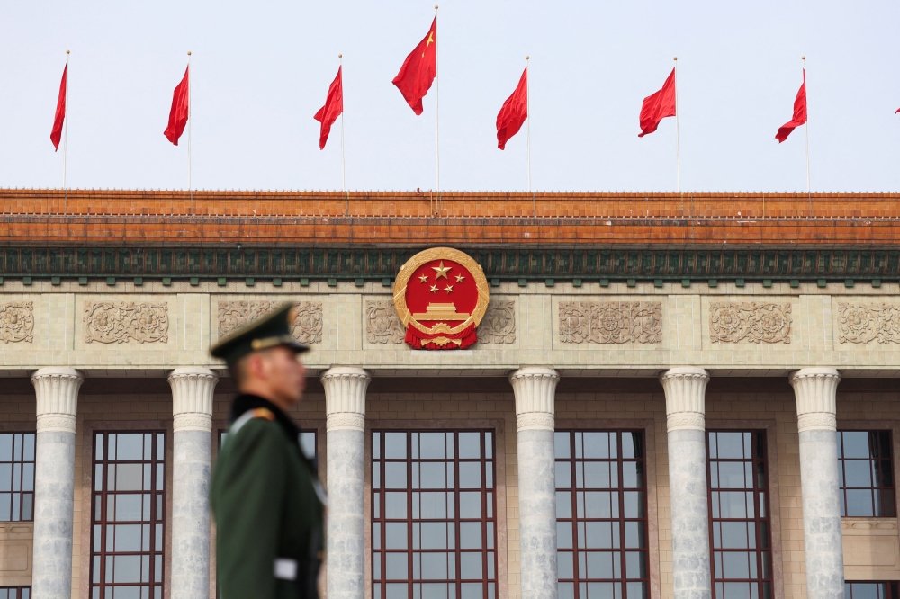 A paramilitary police officer stands guard, on the day of the opening session of the Chinese People’s Political Consultative Conference (CPPCC), in front of the Great Hall of the People, in Beijing, China March 4, 2024. — Reuters pic