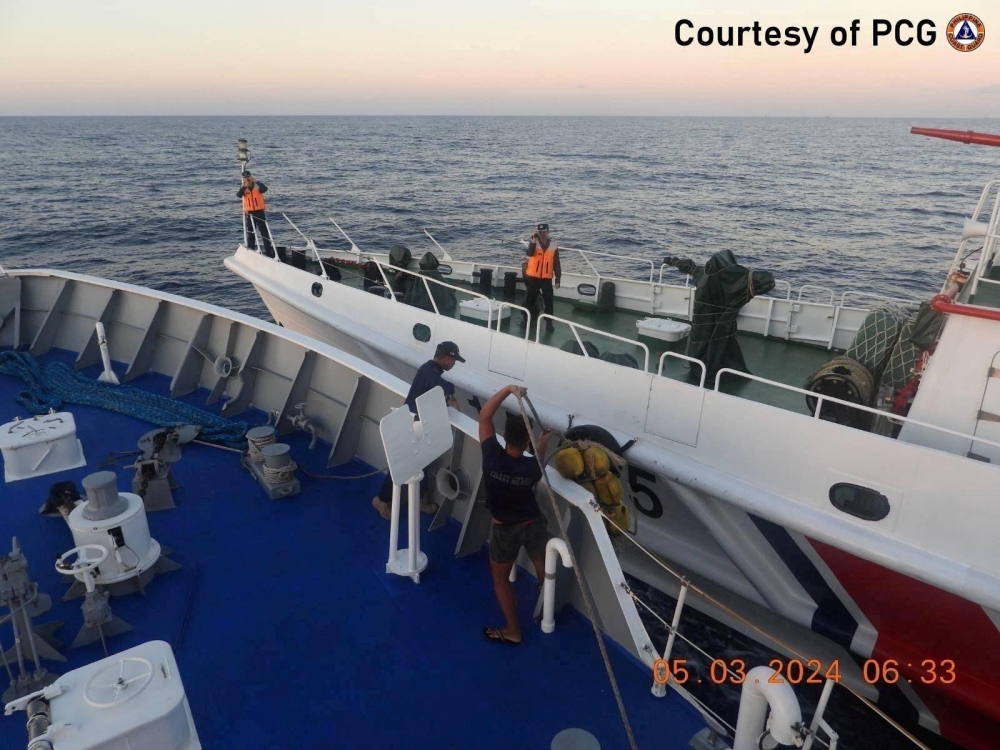 Philippine Coast Guard personnel inspect the hull of the ship during a collision incident between the Philippine Coast Guard vessel BRP Sindangan and a Chinese Coast Guard ship in the disputed South China Sea, March 5, 2024. ― Philippine Coast Guard/Handout via Reuters