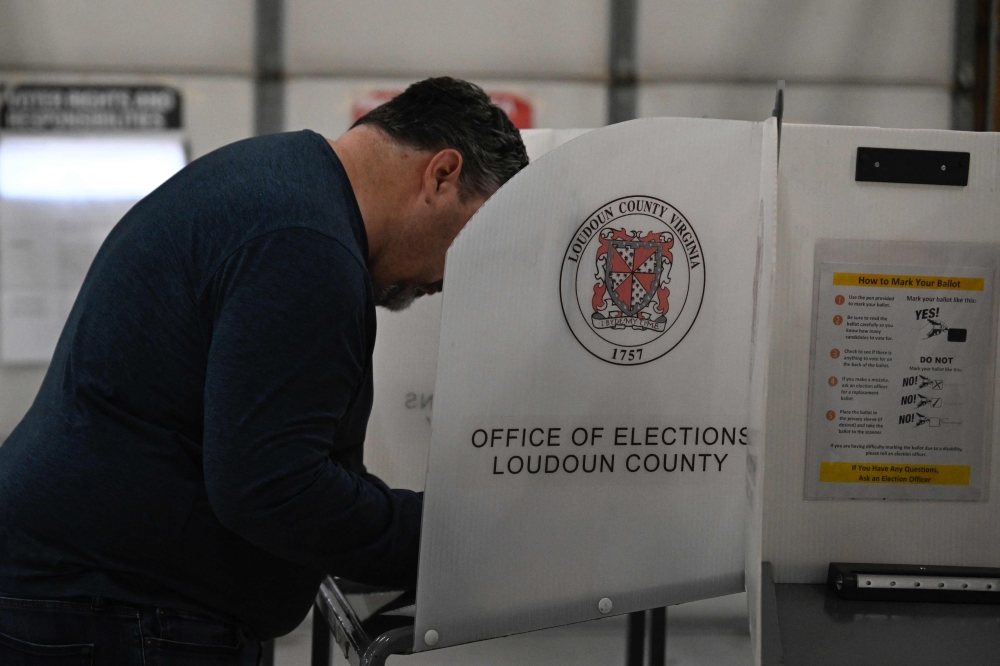 Voters cast their ballots at the Philomont firehouse, on primary election day in Philomont, Virginia on March 5, 2024. — AFP pic