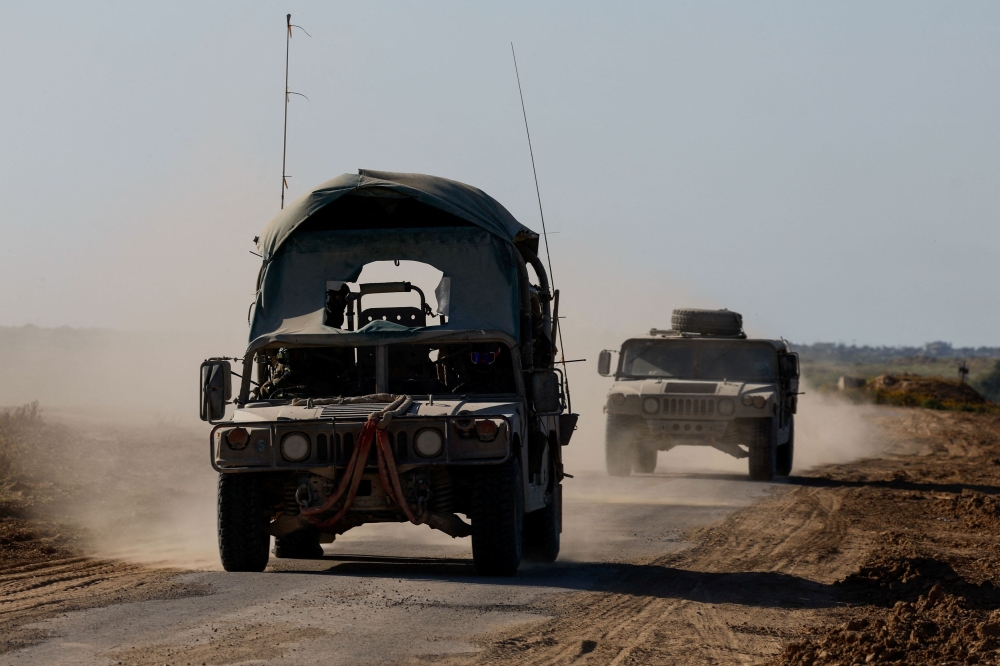 Israeli military vehicles manoeuvre near the Israel-Gaza border, amid the ongoing conflict between Israel and the Palestinian group Hamas, in Israel, March 5, 2024. — Reuters pic