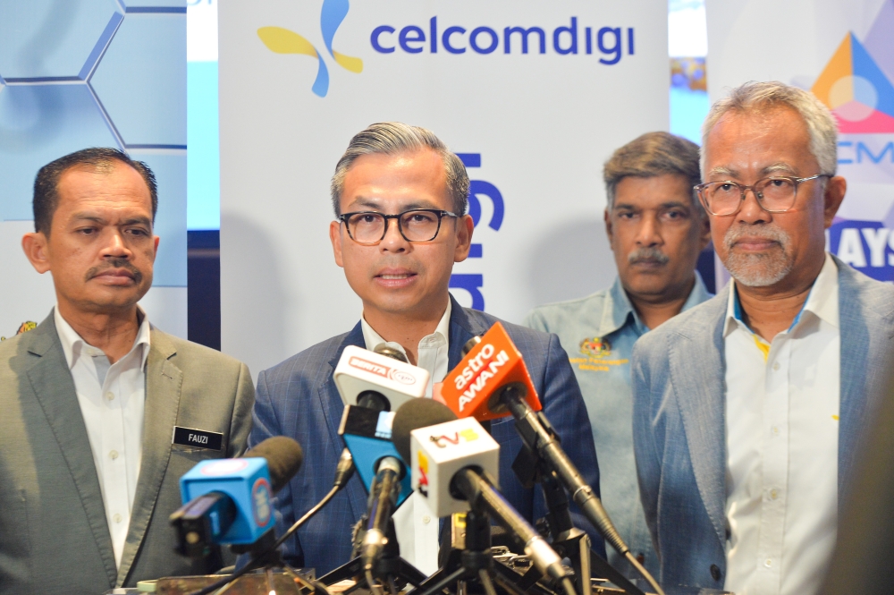 Communications Minister Fahmi Fadzil speaks during a press conference after launching a CelcomDigi product in Petaling Jaya March 6, 2024. — Picture by Miera Zulyana