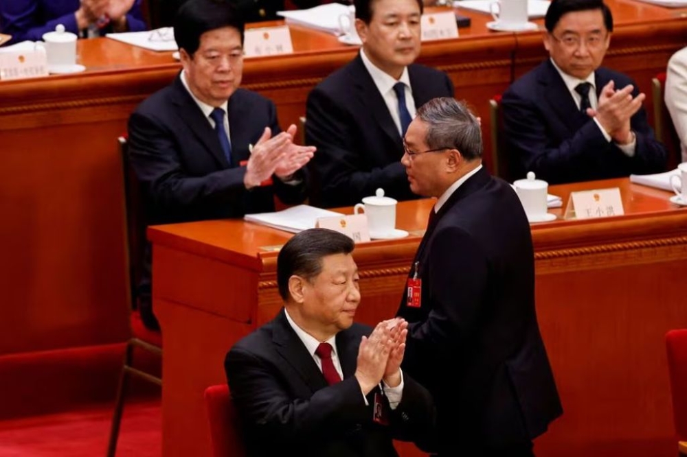 Chinese Premier Li Qiang leaves his seat to deliver the work report at the opening session of the National People’s Congress (NPC) at the Great Hall of the People in Beijing, China March 5, 2024. — Reuters pic