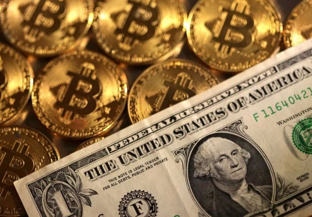 Representations of cryptocurrency Bitcoin and US dollar are seen in this illustration, August 10, 2022. — Reuters pic