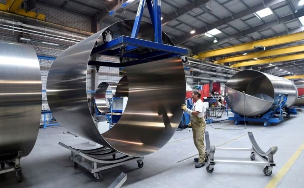 A worker at German manufacturer of silos and liquid tankers, Feldbinder Special Vehicles, moves rolls of aluminium at the company’s plant in Winsen, Germany, July 10, 2018. — Reuters pic
