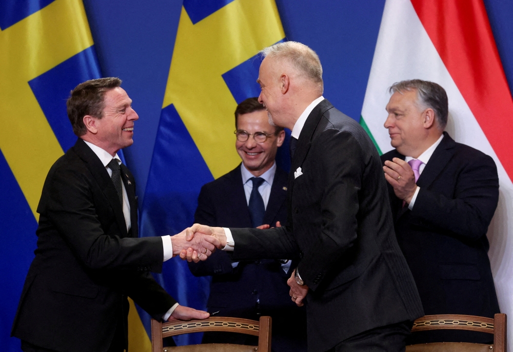 Director General of the Swedish Defence Material Administration Goeran Martensson and Hungary's Kristof Szalay Bobrovniczky shake hands next to Swedish Prime Minister Ulf Kristersson and Hungarian Prime Minister Viktor Orban during a signing ceremony as they meet in Budapest, Hungary, February 23, 2024. — Reuters file pic