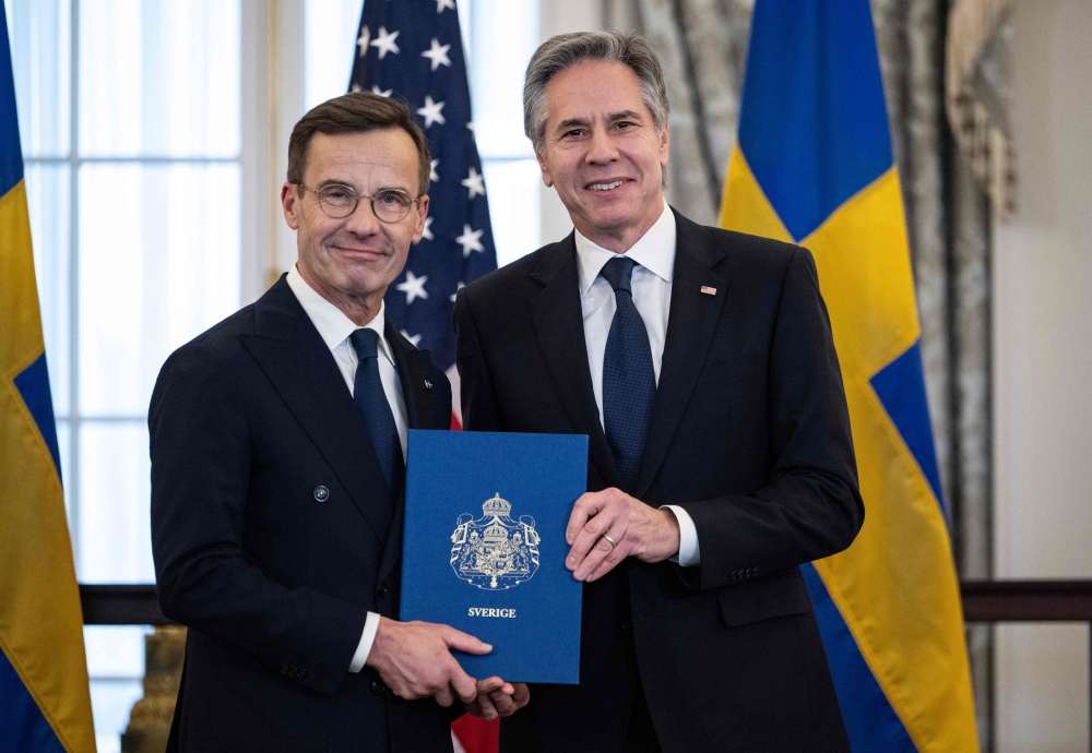 US Secretary of State Antony Blinken receives the Nato ratification documents from Swedish Prime Minister Ulf Kristersson during a ceremony at the US State Department. — AFP pic