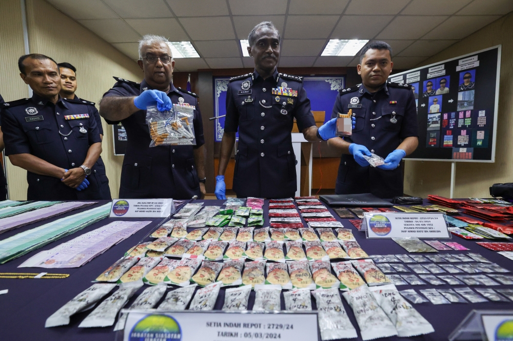 Johor police chief M. Kumar shows the seized narcotics at a press conference yesterday. — Bernama pic