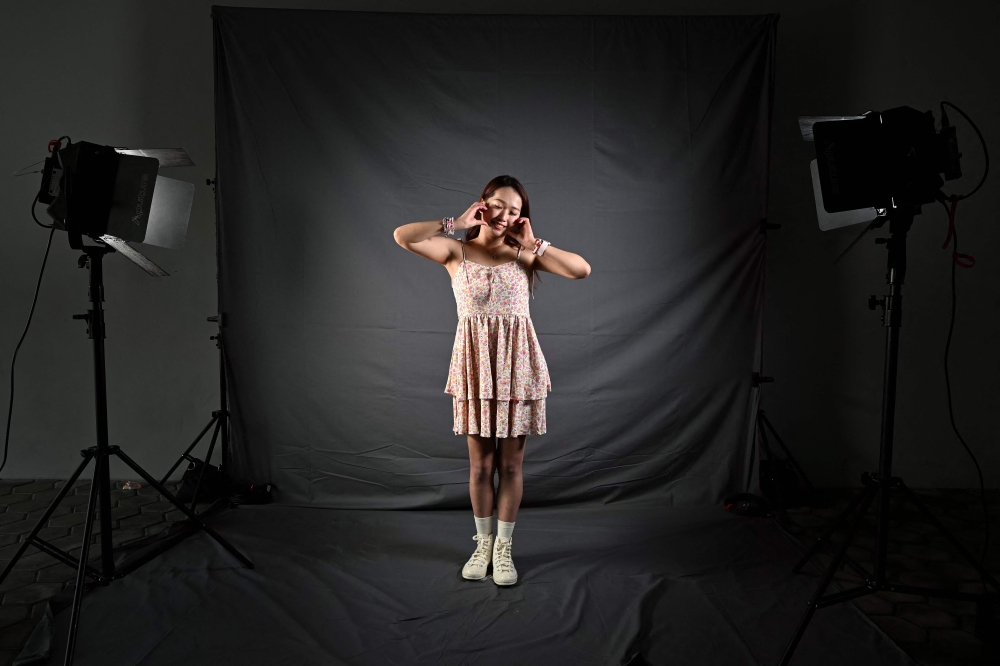 Lauren Fang from Taiwan, a fan of US singer Taylor Swift, also known as a Swiftie, poses for photos before the pop star's Eras Tour concert at the National Stadium in Singapore March 7, 2024. — AFP pic 