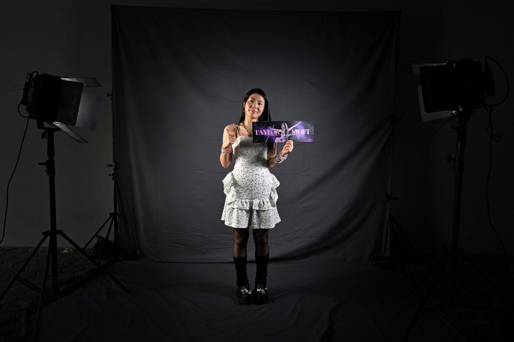 Mona He from China, a fan of US singer Taylor Swift, also known as a Swiftie, poses for photos before the pop star's Eras Tour concert at the National Stadium in Singapore March 7, 2024. — AFP pic 