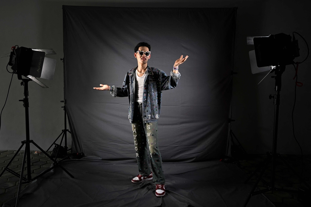Men Ratiee from Thailand, a fan of US singer Taylor Swift, also known as a Swiftie, poses for photos before the pop star's Eras Tour concert at the National Stadium in Singapore March 7, 2024. — AFP pic 
