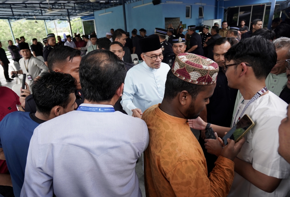 Prime Minister Datuk Seri Anwar Ibrahim greets mosque congregants after Friday prayers at Surau Amaniah at the Putrajaya police headquarters, March 8, 2024. — Bernama pic   