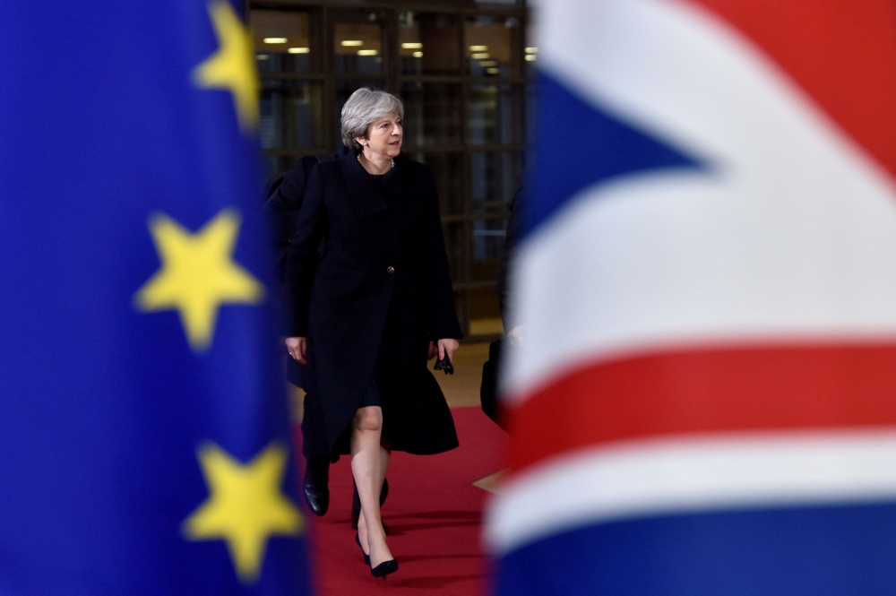 File picture of then British prime minister Theresa May arriving for the EU summit in Brussels December 14, 2017. — Reuters pic  