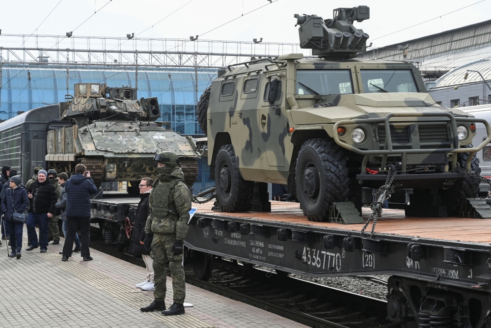 A Russian army serviceman stands in front of military vehicles used in the Russia-Ukraine conflict, including the Ukrainian army’s Bradley infantry fighting vehicle captured by Russian troops, during an exhibition which arrived on a train promoting the Russian army, in Rostov-on-Don, Russia March 3, 2024. — Reuters pic  